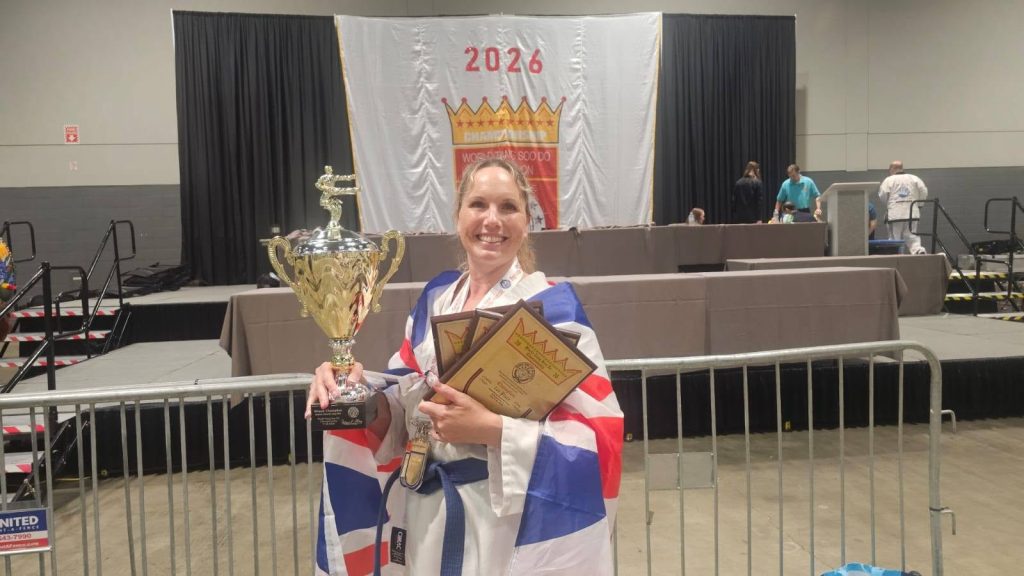 Susie holding the Grand Champion Cup and gold plaques, wrapped in Union Jack