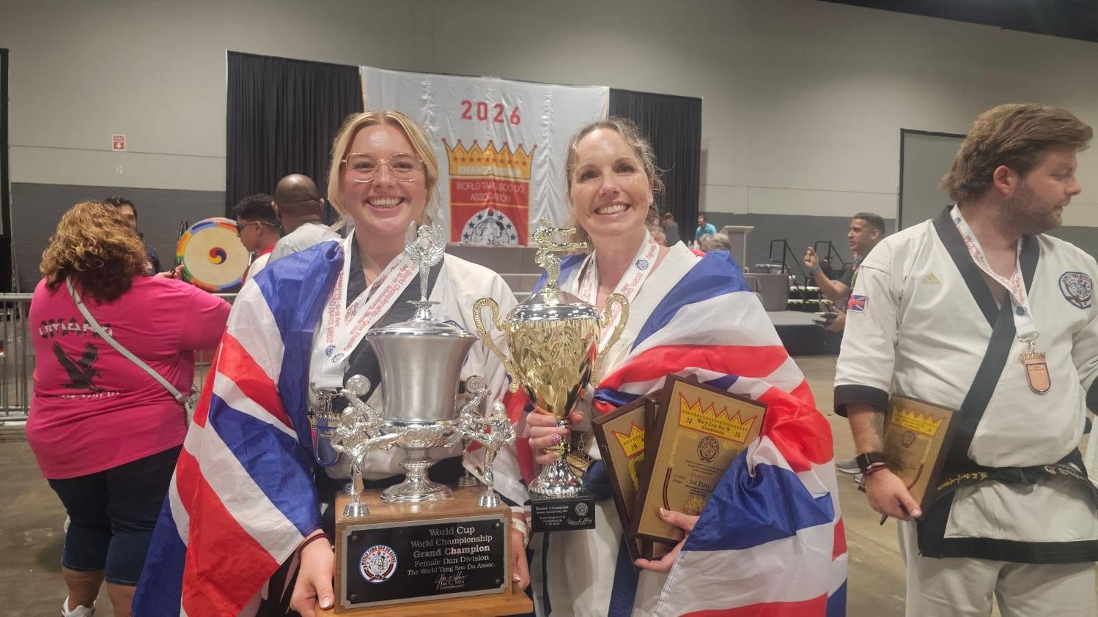 Becky and Susie holding the Grand Champion trophies, wrapped in Union Jacks