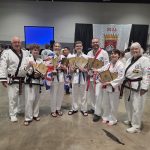 Team members holding trophies and plaques at the World Championships