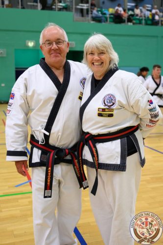 Master Robert Russell and Master Gaynor Russell smiling together in their doboks at the club's August 2026 clinic