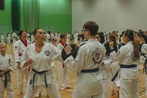 Students in an energetic group exercise at the August 2026 GBTSDA clinic