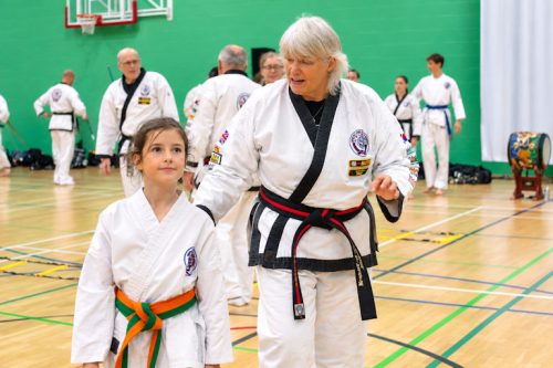 Master Gaynor Russell talking with a young student at the August 2026 GBTSDA clinic