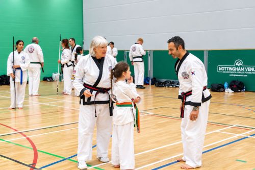 Master Gaynor Russell talking with a young student and a fellow instructor at the August 2026 GBTSDA clinic