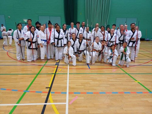 Group photo of all the students and instructors with their bo staffs at the August 2026 GBTSDA clinic